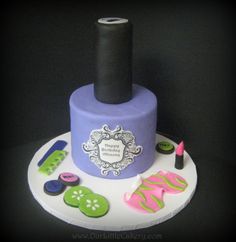 a purple cake with buttons and a black topper