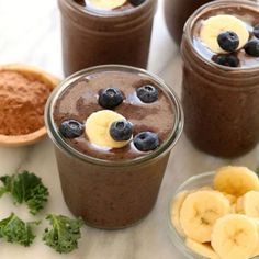 three glasses filled with chocolate smoothie and banana slices