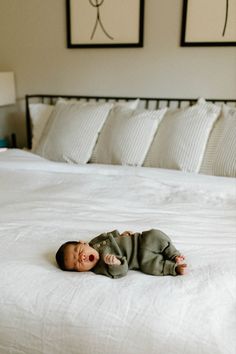 Baby lays on a bed yawning during a lifestyle newborn photoshoot Neutral Family Newborn Picture Outfits, Casual Lifestyle Newborn Photography, Newborn Casual Photos, Newborn Photos Bedroom, Baby Home Photoshoot Ideas, Newborn Inhome Lifestyle Photography, At Home Infant Photoshoot, At Home Newborn Shoot, Candid Newborn Photography