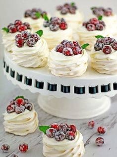 a white cake topped with whipped cream and raspberries