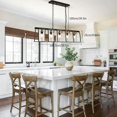 a kitchen island with four stools in front of it