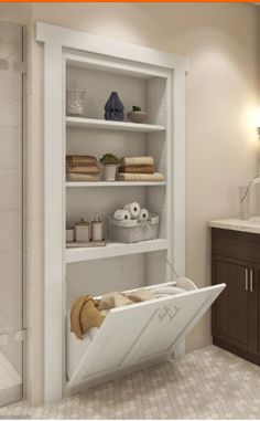 a bathtub in the middle of a bathroom with shelves full of towels and toiletries