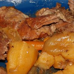 a blue plate topped with meat and potatoes