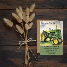 there is a card with a tractor on it next to some pamodia stalks