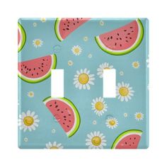 a light switch cover with watermelon slices and daisies on blue background,