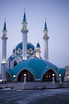 a large white and blue building with two towers