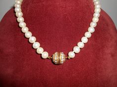 "A dazzling vintage single strand pearl necklace with rhinestone trim This vintage necklace is gorgeous. It has a single strand of white pearl beads and each bead is hand tied. The closure on this necklace is a round goldtone ball studded with rhinestones. It really sparkles. This vintage pearl necklace is perfect for daytime or evening. MATERIAL: Pearl beads, rhinestones CONDITION: It is in very good condition SIZE: It measures 18\" in length plus closure COLOR: White pearl beads, goldtone sett Classic White Necklace With Rhinestones, Classic White Rhinestone Necklace, White Pearl Necklace With Rhinestones For Formal Occasions, Formal Pearl Necklace With Rhinestones, Elegant Pearl Necklace With Rhinestones For Gift, Formal White Pearl Necklace With Rhinestones, Elegant Pearl Necklace With Rhinestones For Formal Occasions, Elegant Formal Pearl Necklace With Rhinestones, Vintage Pearl Necklace