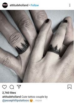 two people with matching rings on their fingers and trees tattooed on the middle of their fingers