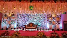 the stage is decorated with flowers and chandeliers