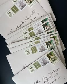 several envelopes with writing on them are lined up in different sizes and shapes,