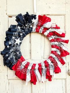 a patriotic bandana wreath is hanging on a white door with the words patriotic bandana wreath