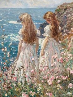 two women in white dresses standing on the edge of a cliff overlooking the ocean with pink flowers