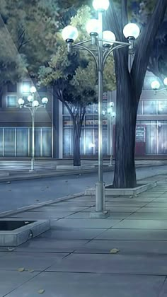 a man is walking down the street in front of a lamp post at night time