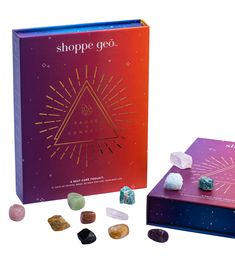 a purple box and some rocks on a white background with the words shoppe go written in gold