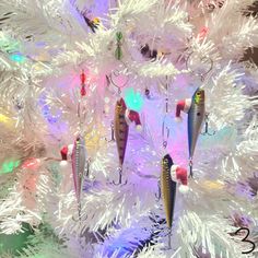 a white christmas tree with fishing lures hanging from it