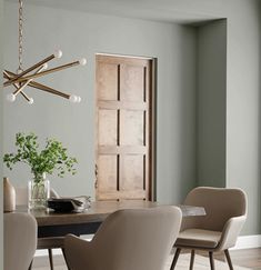 a dining room table with chairs and a chandelier