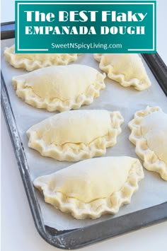 four uncooked dumplings on a baking sheet ready to go into the oven