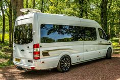 a white van is parked in the woods