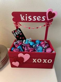 a valentine's day treat box filled with chocolates and candy hearts that say kisses