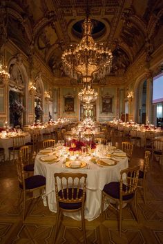 a fancy dining room with chandeliers and tables set up for an event or function