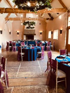 a banquet hall with blue and purple linens