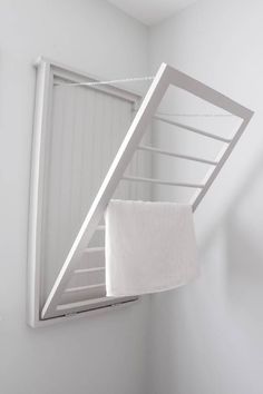 a white towel is hanging on the clothes rack