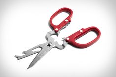 a pair of red handled scissors on a white background