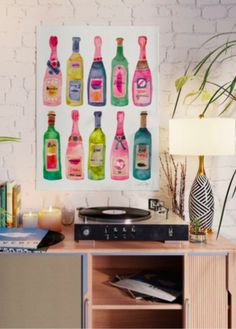 there are many bottles on the table next to each other and one is holding a record player