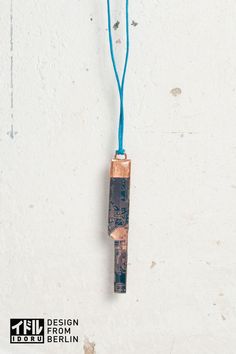 a piece of wood hanging from a blue cord