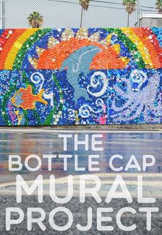 the bottle cap mural project in front of a building with an ocean theme on it