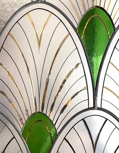 an art deco stained glass window with green and white designs