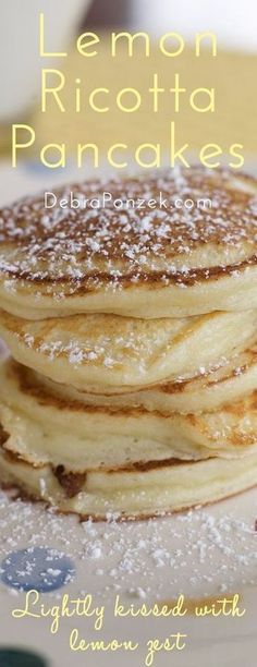 a stack of pancakes with powdered sugar on top and the words lemon ricotta pancakes below