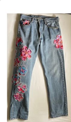 a pair of jeans with flowers on them