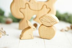 two wooden toy rabbits sitting next to each other