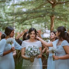 the bridesmaids are getting ready to go into their wedding ceremony at the park