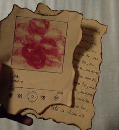 someone holding up a piece of paper that has been altered to look like roses on it