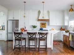 the kitchen is clean and ready for us to eat in it's white cabinetry