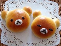 two teddy bears made out of bread on a doily