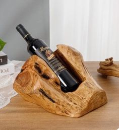 a bottle of wine sitting on top of a wooden stand