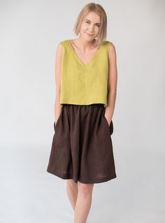 "Relaxed fit sleeveless linen crop top with wide V-neck creates a romantic and careless look. Because of its versatility suitable in many combinations and for various occassions. Something that doesn't require time or effort to make you look stylish and subtly seductive. DETAILS - Relaxed fit - Fits true to size - can be made shorter or longer depending on your preference - Wide V neckline - Sleeveless - 100% midweight 185 g/m2 European softened linen fabric - Oeko Tex certified linen - Various Sleeveless Linen Crop Top For Summer, Sleeveless Linen Crop Top For Spring, Summer Cropped Linen Tank Top, Summer Cropped Linen Tops, Linen Summer Crop Top Tank Top, Summer Linen Crop Top Tank, Cropped Linen Top For Summer, Chic Sleeveless Linen Crop Top, Green Linen Tank Top For Summer