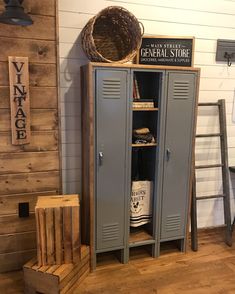 a large metal locker sitting in the corner of a room next to a wooden crate