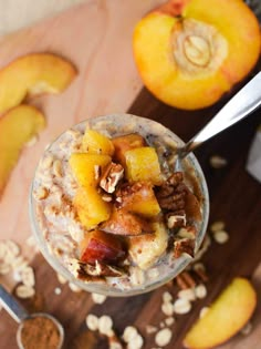 an oatmeal with fruit and nuts in a glass on a cutting board