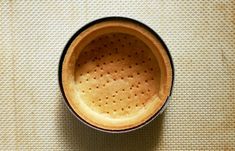 an empty cup sitting on top of a table