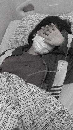 a man laying in a hospital bed with an oxygen tube wrapped around his neck and head