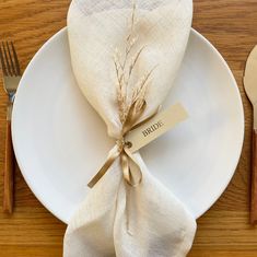 a white plate topped with a napkin and fork