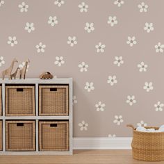 the wallpaper in this nursery room is decorated with white flowers and wicker baskets