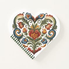 a heart shaped paper with an ornate design on it