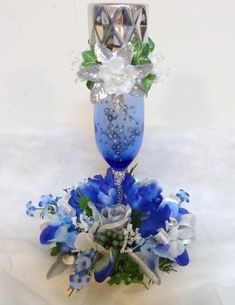 a blue glass vase with flowers on it