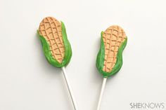 two green and white marshmallows shaped like corn on the cob with peanut butter