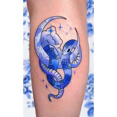 a tattoo on the leg of a woman with an elephant and moon in the sky